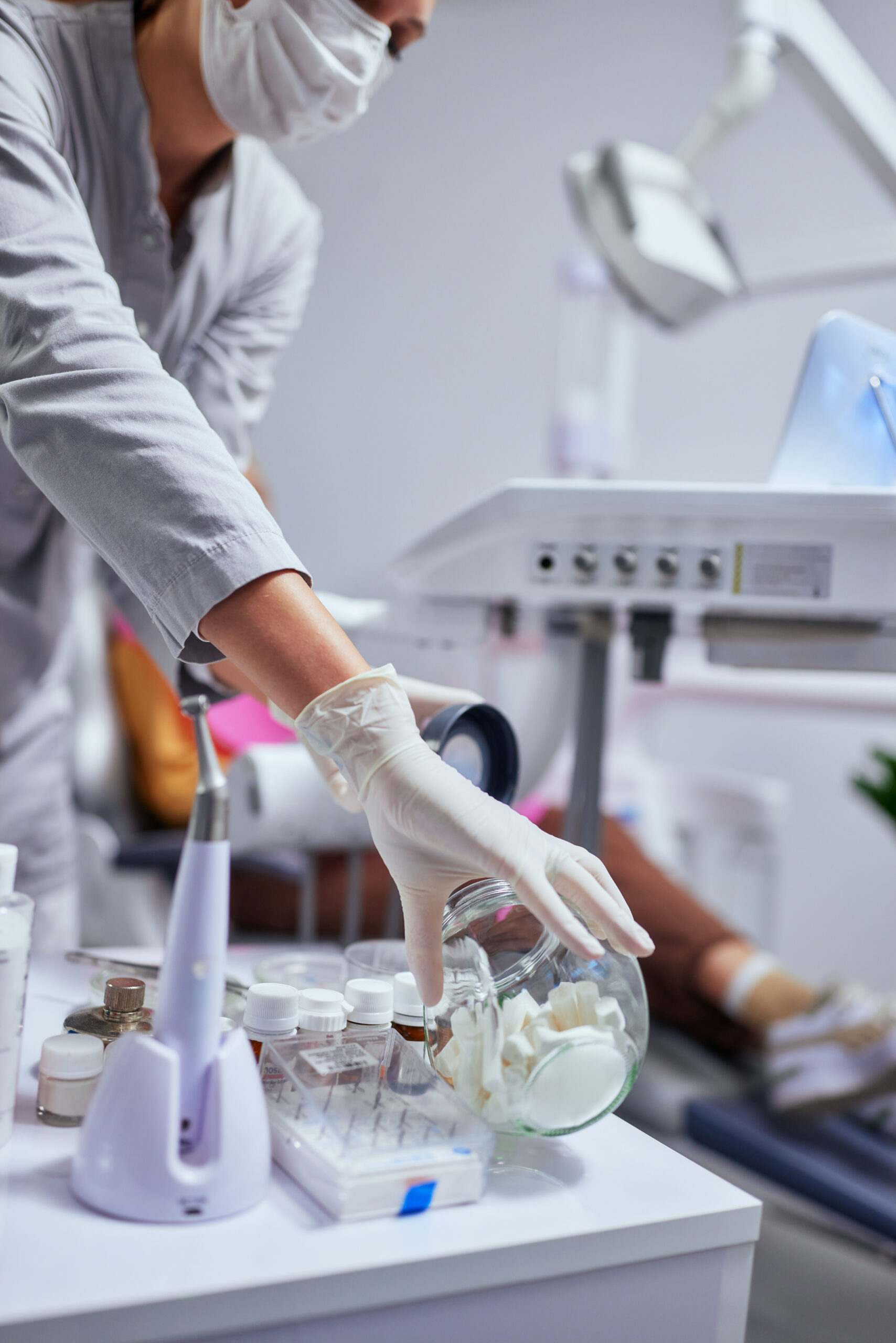 Close up of unrecognized dentist taking appropriate tool during dental treatment